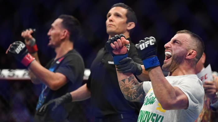 Dec 14, 2019; Las Vegas, NV, USA; Alexander Volkanovski (blue gloves) reacts after defeating Max Holloway (red gloves) during UFC 245 at T-Mobile Arena